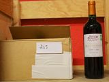 a bottle of wine sitting next to a cardboard box