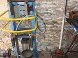 a picture of a room with a blue cart and a yellow hose