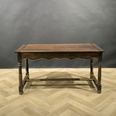 an old wooden table on a parquet floor with a gray background