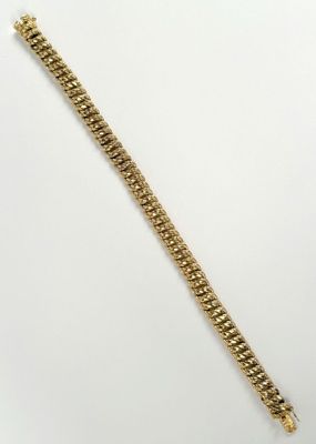 a gold bracelet on a white background