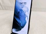 a close up of a phone on a table with a white background
