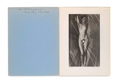 an open book with a picture of a man in a spider web
