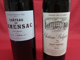 two bottles of wine sitting next to each other on a table