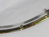 an old sword with a wooden handle on a white surface