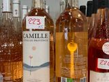 several bottles of wine are lined up on a counter