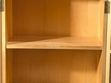 a small wooden cabinet with two shelves on it