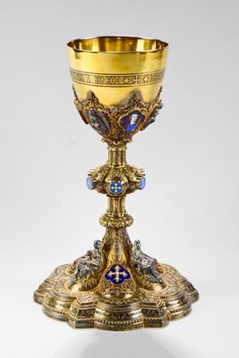 an ornate gold chalicet with a blue and white cross on it