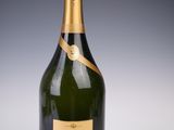 a bottle of champagne with a gold label on it
