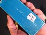 a person holding a blue box with a sticker on it