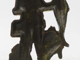 a statue of a man holding an umbrella on a rock