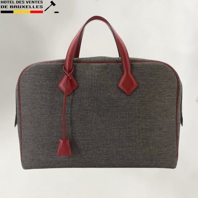 an image of a grey and red handbag on a white background
