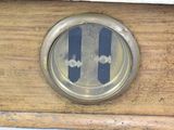a clock that is on the side of a wooden table
