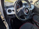 the interior of a small car with red trims and a steering wheel