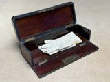a wooden box with gloves in it on a table