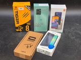 three boxes of various cell phones sitting on a table next to each other