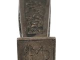 a silver cuff that has a picture of a man on it