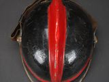 a close up of a helmet with a red stripe on it
