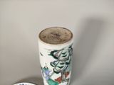 a small vase and a small plate on a table