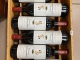 bottles of red wine in a wooden box on a tiled floor