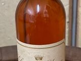 a bottle of whiskey sitting on a wooden table