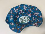 an image of a blue bowl with pink flowers on it