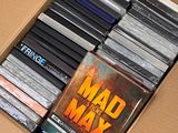 a cardboard box filled with dvds and cds