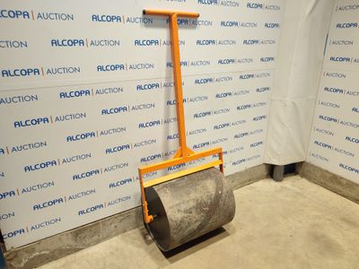 a floor roller in the middle of a room with a sign on the wall behind it