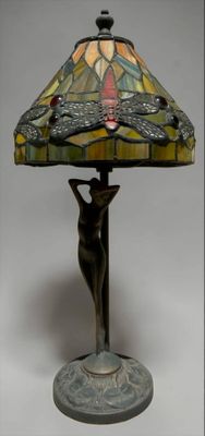 lamp with a bronze base and a stained glass shade on top