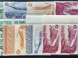 several different colored stamps on a black surface with a plane in the background