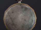 an old silver pocket watch with a chain around the face