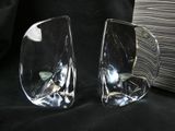 two glass vases sitting next to each other on a black cloth