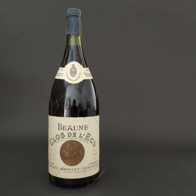 a bottle of red wine on a black background