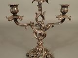 silver plated candelab with three candles and a bird on the top