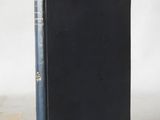 a black book with a blue cover sitting on top of a table