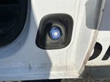a close up of a white truck door with a blue cap