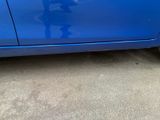 a blue car that is parked on the side of the road