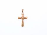 a close up of a gold cross on a white background