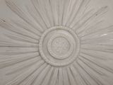 a white ceiling with a sunburst on it