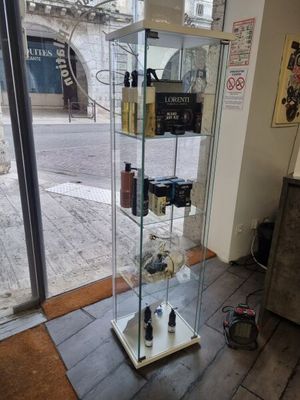 a glass display case with a lot of bottles in it