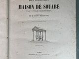 an open book with a drawing of a building on it