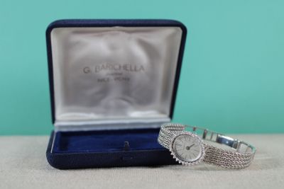 an image of a watch and a ring in a box