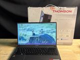 a laptop that is sitting on a table with a charger