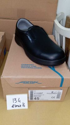 a box with a pair of black shoes on top of it