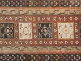 a brown and black rug with a pattern on it