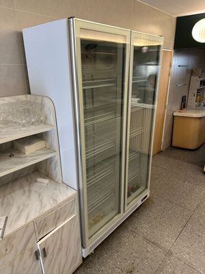 a refrigerator that is sitting in the middle of a room
