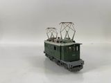 a green train on a white surface with a white background