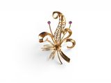 a close up of a gold broochle with pink stones