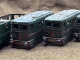 several toy trains are lined up in a row on the ground