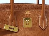 brown leather handbag with gold hardware on a white background
