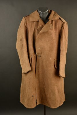 a brown coat on a mannequin stand against a black background